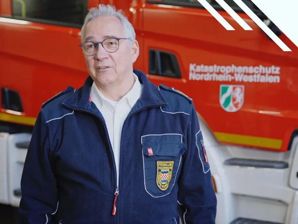 Feuerwehrmann vor einem Löschfahrzeug